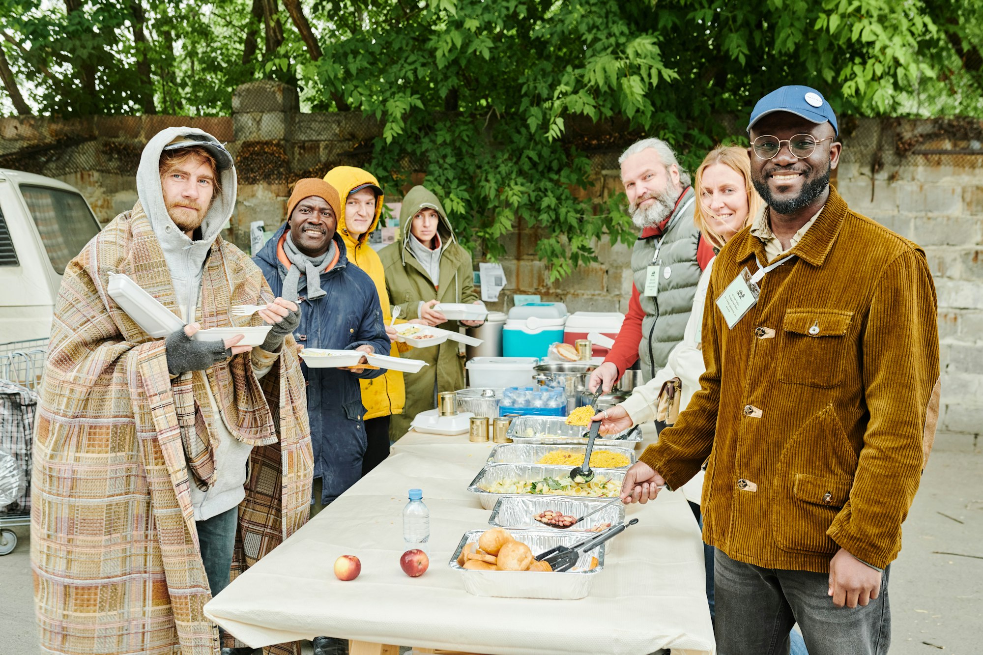 Volunteers helping homeless people with food